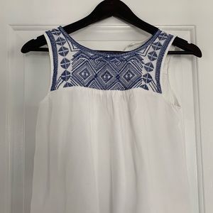 Embroidered crop tank with pompom hem detail